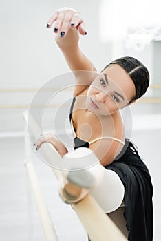 graceful woman stretching on barre in