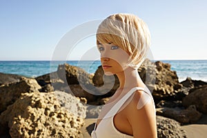 Graceful woman in white swimwear on the beach