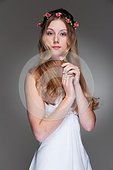 Graceful young woman with flowers