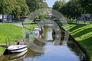 Gracht or canal with leisure boats in Friedrichstadt, the beautiful town and travel destination in northern Germany founded by photo