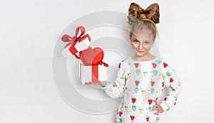 Gracious little girl with blond hair and blue eyes standing on a white background wearing a sweatshirt and a strawberry