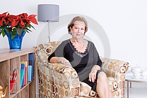 Gracious senior woman relaxing at home