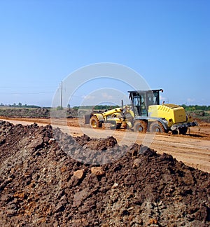 Grader adjust elevation level soil