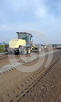 Grader adjust elevation level soil