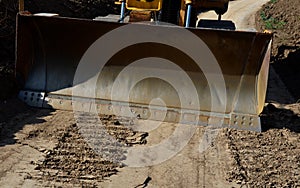 Grader, bulldozer flats the road surface. tears unevenness with a large blade. a perfectly level surface is created which crushes