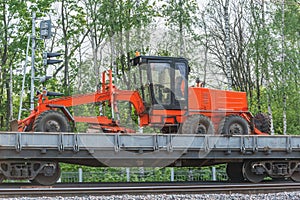 Grader stands on the railway transporter.