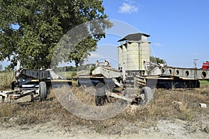 Grader on a trailer for heavy equipment. Trailer Hitch for tractors and combines. Trailers for agricultural machinery