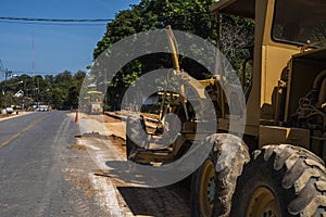 Grader is working on road construction. Grader industrial machine on construction of new roads. Heavy duty machinery
