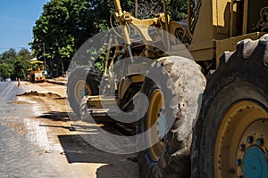 Grader is working on road construction. Grader industrial machine on construction of new roads. Heavy duty machinery