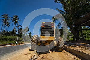 Grader is working on road construction. Grader industrial machine on construction of new roads. Heavy duty machinery