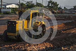 Grader is working on road construction. Grader industrial machine on construction of new roads. Heavy duty machinery