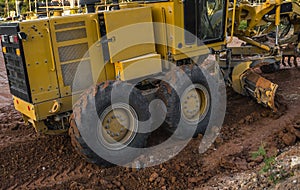 Grader is working on road construction. Grader industrial machine on construction of new roads. Heavy duty machinery