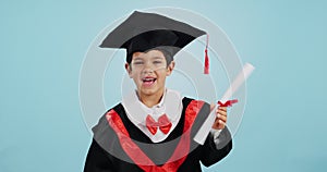 Graduate, child and celebration with portrait and happiness in studio on blue background for education. Development, kid