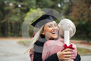 Graduate girl hugging mother