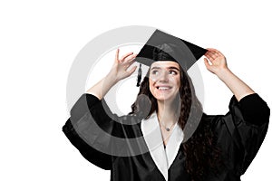 Graduate girl with master degree in black graduation gown and cap on white background. Happy young woman careerist have