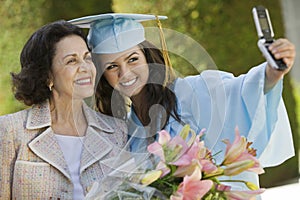 Graduate And Grandmother Taking Picture With Cellphone