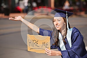 Graduate with Hire Me Sign photo