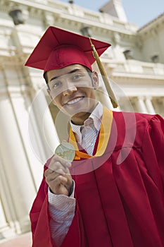 Graduate Holding Medal portrait