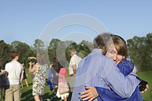 Graduate hugs her dad after commencement photo