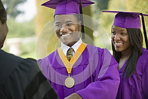Graduate Looking At Cropped Dean With Friend