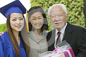 Graduate with mother and grandfather outside portrait