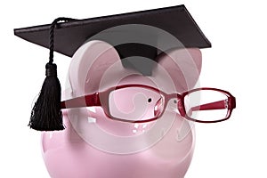 Graduate Piggy Bank student graduation, education savings concept, close up