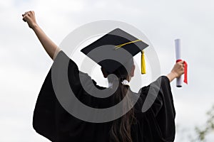 Graduate put her hands up and celebrating with certificate