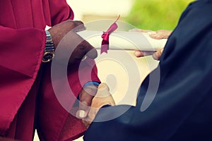 Graduate Receiving Diploma and Handshake