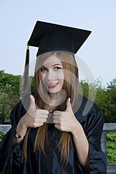 Graduate student with thumbs up sign