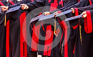 Graduate Students hold hats in hands in university graduation success ceremony. Congratulation on Education Success, Graduation