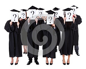 Graduate students showing question signs