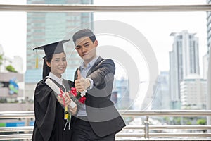 Graduate Students and Success Education in University Concept. Happy Couple of Asian students graduate diploma and MBA degree in