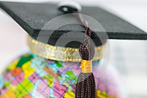 Graduate study abroad concept, Graduation cap on top Earth globe model map on laptop with Radar background. Graduate study abroad