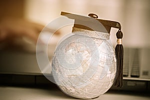 Graduate study abroad concept, Graduation cap on top Earth globe model map with Radar background. Graduate study abroad program an