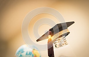 Graduate study, Education knowledge power concept: Hands holding light bulb with Graduated cap. Conceptual for Educational Sparked