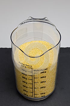 a graduated container of corn