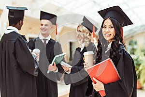 group of graduated multiethnic students with coffee spending