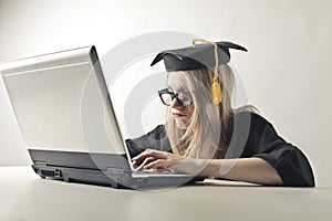 Graduated woman at the laptop