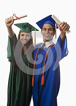 Graduates in cap and gown with diploma