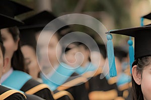 Graduates in commencement graduation ceremony row, metaphor educ