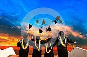 Graduates throwing graduation hats