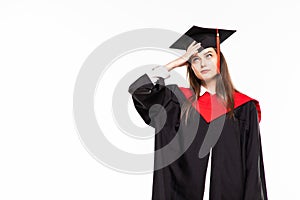 Graduating student girl in an academic gown isolated over white background