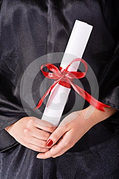 Graduating student holding her diploma