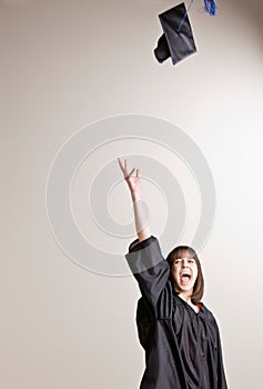 Graduating student throwing cap in air