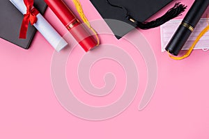 Graduation academic cap with diploma and mask isolated on pink table background