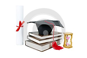 Graduation cap with diploma and hourglass on table