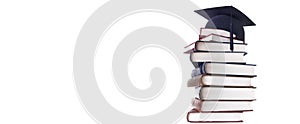 Graduation cap on a hight stack of books photo