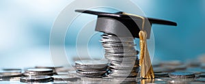 The Graduation Cap Perched on a Stack of Coins Represents Financial Success.AI generated image