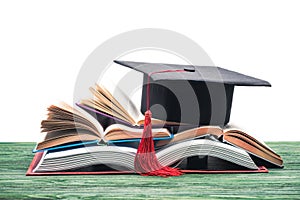 Graduation cap on stack of open books