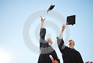Graduation cap throw, blue sky and friends after a diploma, certificate and degree ceremony event. Education, university